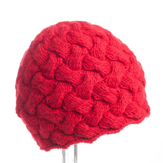 A red Holden Beanie displayed on a stand against a white background.