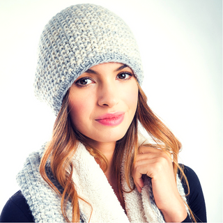 A young woman wearing a Marich Pattern Long Pull On Cap and scarf.