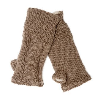 The Cable Handwarmers are brown Merino wool fingerless gloves with a cable knit pattern, stacked on a white background. These stylish, cozy winter gloves for women provide warmth and elegance.