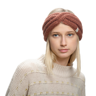 A woman wearing a Veronica Headband, which is handmade and brown knitted.