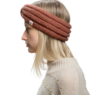 A woman wearing a Veronica Headband, made of brown, wool knitted material.