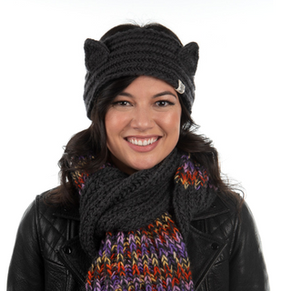A smiling woman wearing a Kit Kat headband and a multicolored scarf.