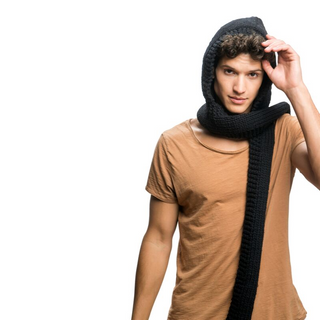 A young person wearing a brown North Face Hood Scarf with merino wool and sherpa fleece lining, tipping their hat with a casual gesture, isolated on a white background.