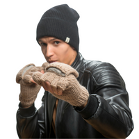A person wearing a black knit beanie, a black leather jacket, and Hand Knit Fingerless Gloves With Button Flap and Fleece Lining raises their fists in a boxing stance against a white background.