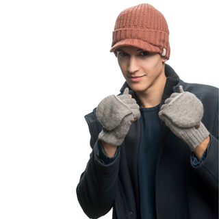 A man wearing Bryant Fingerless Gloves with Flap, a hat, and applying anti-aging skincare.