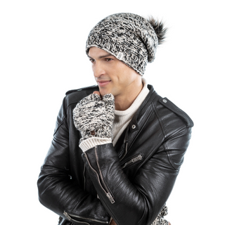 A person in a black leather jacket with a matching knitted hat and Bedford Fingerless Gloves with flap, handmade in Nepal, looking thoughtfully to the side.