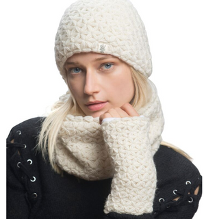 A woman wearing a white merino wool knitted beanie and matching I See Stars Merino Handwarmers, with her hand near her face, isolated on a white background.