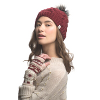 A woman models the Dreams Hand Crochet Handwarmers, pairing them with a red knit pom-pom hat and a cream sweater with pearl details against a white background.