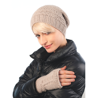 A woman wearing a beige knitted Cable Handwarmers and organic gloves.