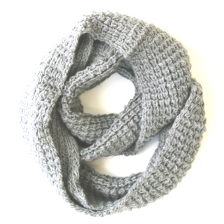 A handmade Double Wide Infinity Scarf made of merino wool on a white background.