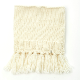 A cream-colored knitted Sweet Emotions Neckwarmer with tassels on the edge, handmade in Nepal, displayed on a white background.