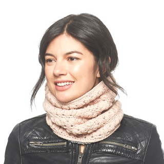 A woman wearing a Good Vibes Neckwarmer and a black leather jacket is looking to the side with a slight smile on her face.