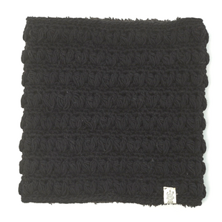 Original sentence: A handmade in Nepal, black textured cushion with a visible label on the lower right corner displayed against a white background.
Revised sentence: A Good Vibes Neckwarmer handmade in Nepal, with a visible label on the lower right corner displayed against a white background.