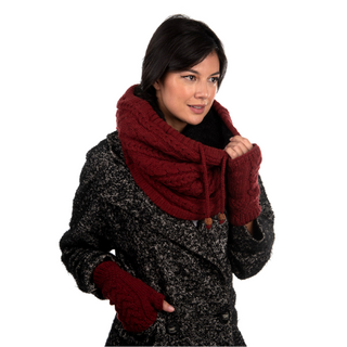 A woman wearing burgundy Cable Handwarmers made from organic fibers.