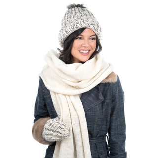 A woman wearing a hat and an Air Wrap Scarf made from merino wool.