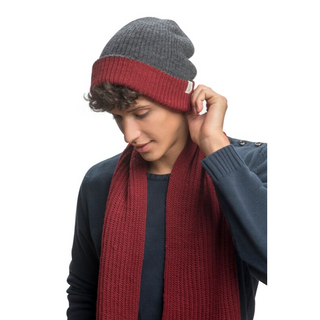 A man wearing a burgundy beanie and a Laurent Scarf.