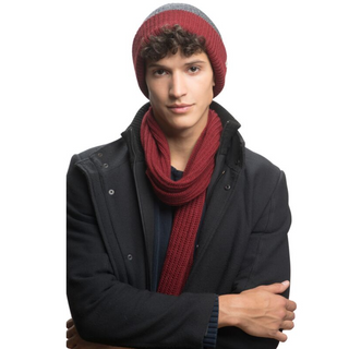 A young man wearing a handmade burgundy Laurent Scarf and hat.