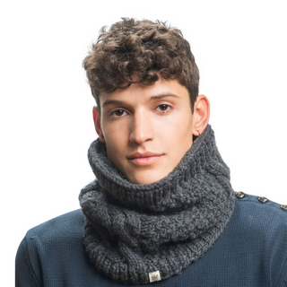 A young man with curly hair wearing a Margins Neckwarmer with sherpa fleece lining and a blue top, looking directly at the camera against a white background.