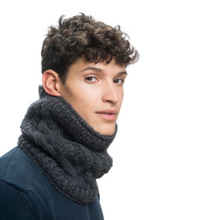A young man with curly hair wearing a dark sweater and a thick gray Margins Neckwarmer with sherpa fleece lining, looking over his shoulder with a neutral expression, against a white background.