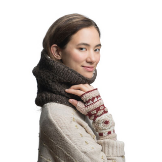 A woman with a subtle smile wearing a cream-colored sweater and a Margins Neckwarmer against a white background.