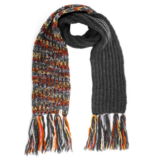 A Prelude Scarf with one half featuring a multicolored pattern and the other half in solid dark grey, both ends adorned with fringes.