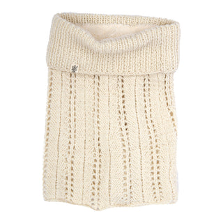 A cream-colored, merino wool Lacey neckwarmer with a folded collar and a small metal emblem on the lower side.