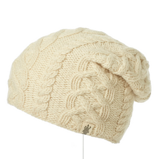 A cream-colored Oslo Braid Knit Slouch beanie hat with a decorative knotted design on the side, handmade in Nepal.