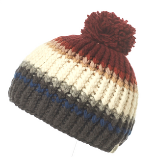A multicolored handmade in Nepal Hi Fidelity Beanie w/ Pom with a red pompom on top.