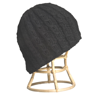 A Small Chain Knit Beanie displayed on a wooden head stand.