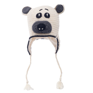 A hand-crocheted Crochet Bear Hat designed to resemble a panda's face with ear flaps and tassels, crafted from 100% wool.