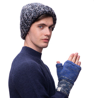 A young man wearing a blue Marbled rib fold beanie and fingerless gloves.