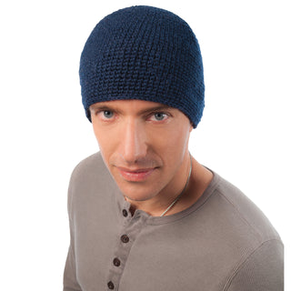A man wearing a blue wool crochet seed beanie.