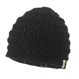 A handmade in Nepal black crocheted Good Vibes Beanie displayed against a white background.