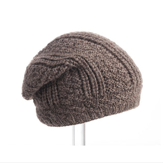 A brown handmade knitted Caliber Slouch on a stand.