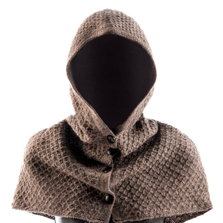 A headless mannequin wearing a handmade wool hooded cape with Buttoned Hood, crafted in Nepal.