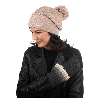 A woman wearing a knit beanie and leather jacket with Hi Fidelity Mittens handmade in Nepal, merino wool smiles and looks to the side.