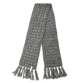 A handmade Oslo Scarf with a patterned texture and tasseled ends.
