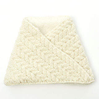 A cream-colored Dream On Neckwarmer neatly folded on a white background.